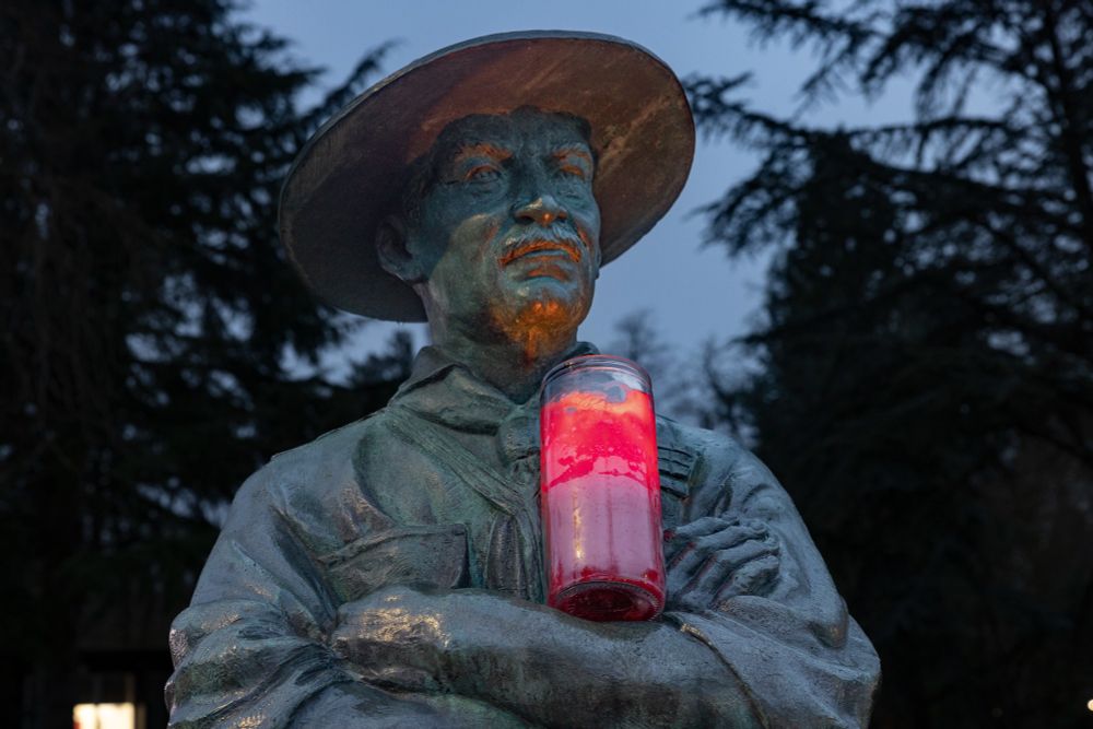 Lord Baden-Powell's bust illuminated by the Peace Light flame at Gilwell Park