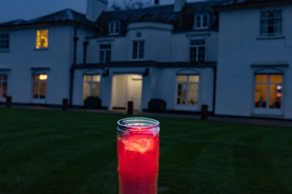 The Peace Light flame glowing red in front of the White House ar Gilwell Park