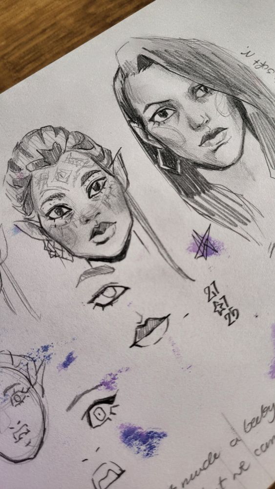 A picture of a messy sketchbook page. In the middle, there are two portraits, front view. One is of Bellara, the other looks like an uglier cousin of Neve Gallus who wants so bad to be her. Both are companions in Dragon Age The Veilguard. Their portraits are surrounded by loose sketches of eyes and lips and stains from bleed through markers