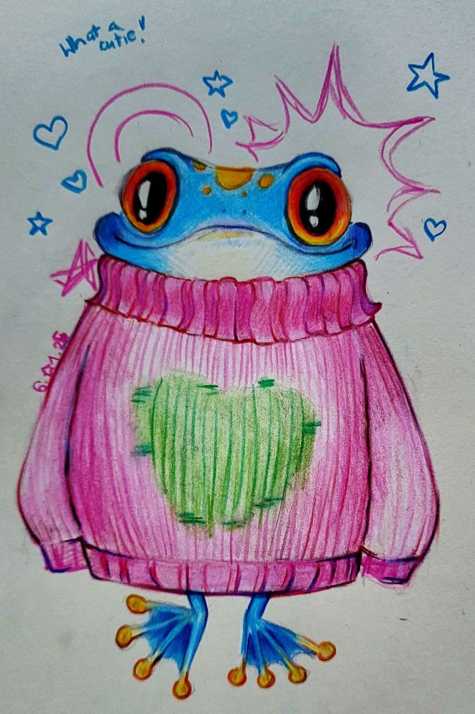 A front view of a blue frog with yellow dots on its forehead and big orange eyes. It's wearing a pink oversized sweater with a green heart on the front of it