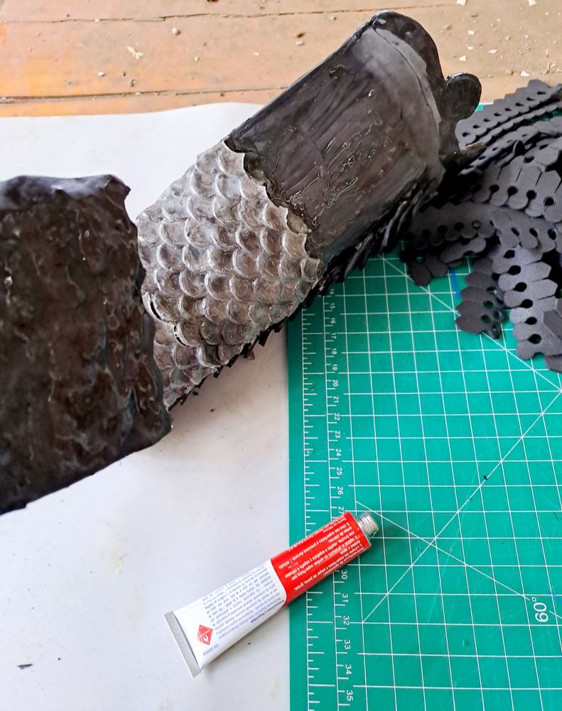 Gluing mold scales on leg.
