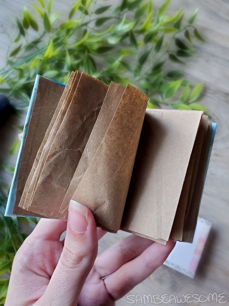 The inside of the junk journal with brown packaging paper making up the pages.