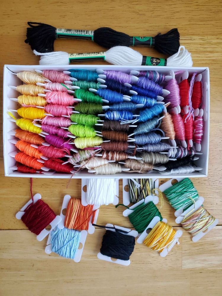 A photo of a rainbow collection of embroidery floss.