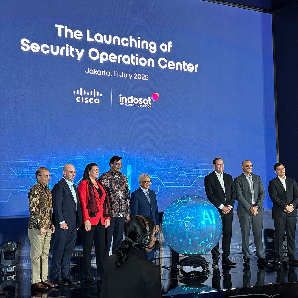 A group of people including Chuck and Jeetu on stage at the security op center.