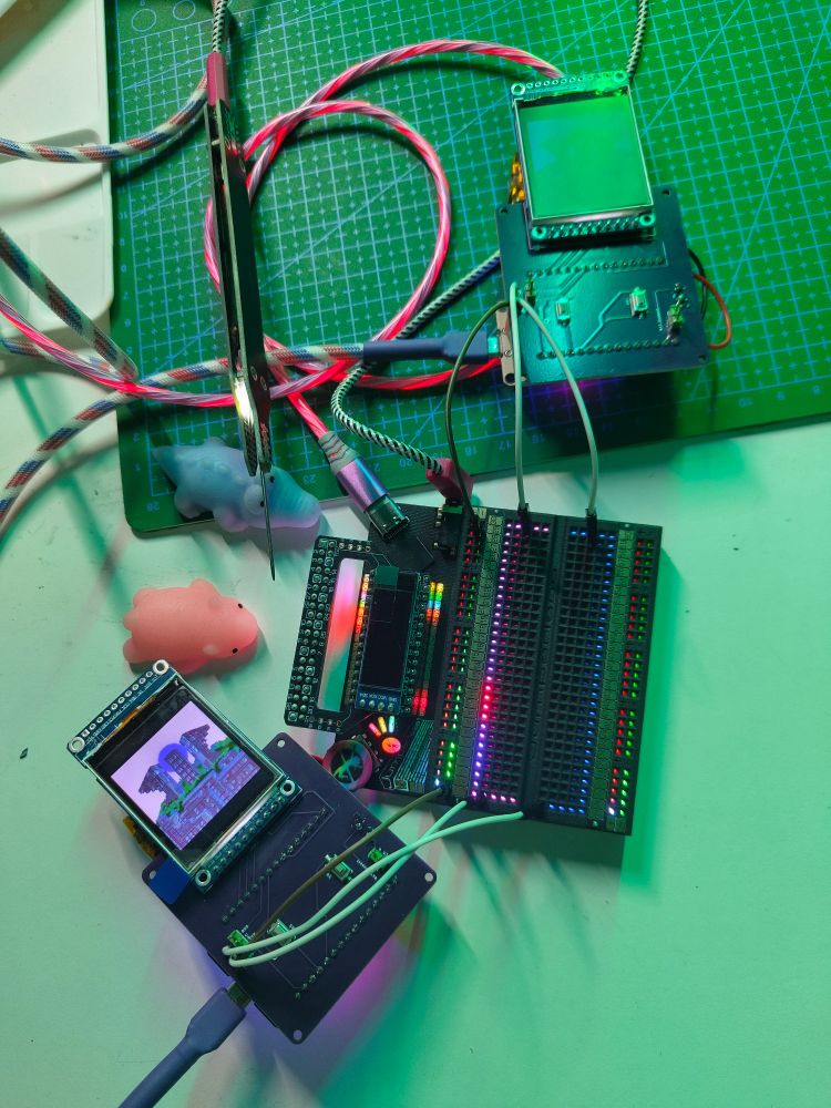 Two circuit boards are connected to the Jumperless breadboard. The Jumperless breadboard uses LEDs to highlight connections rather than physical jumpers. 