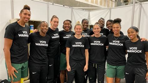 WNBA players wearing “Vote Warnock” t-shirts 