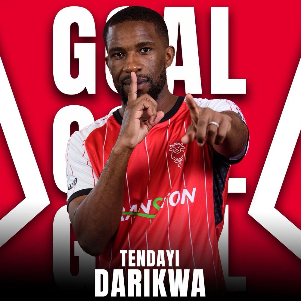 Graphic from Lincoln city social media: Tendayi Darikwa stands in red home kit pointing at the camera with one hand and the index finger of his other pressed to his lips to say shhhhhhhhhh