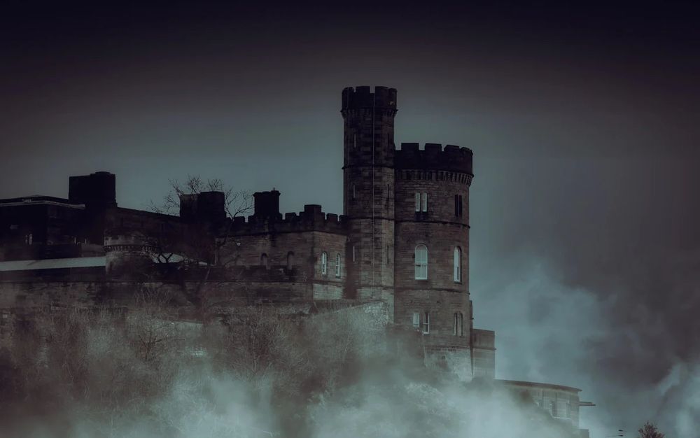 A very haunted castle. Silhouetted in dramatic fog. 