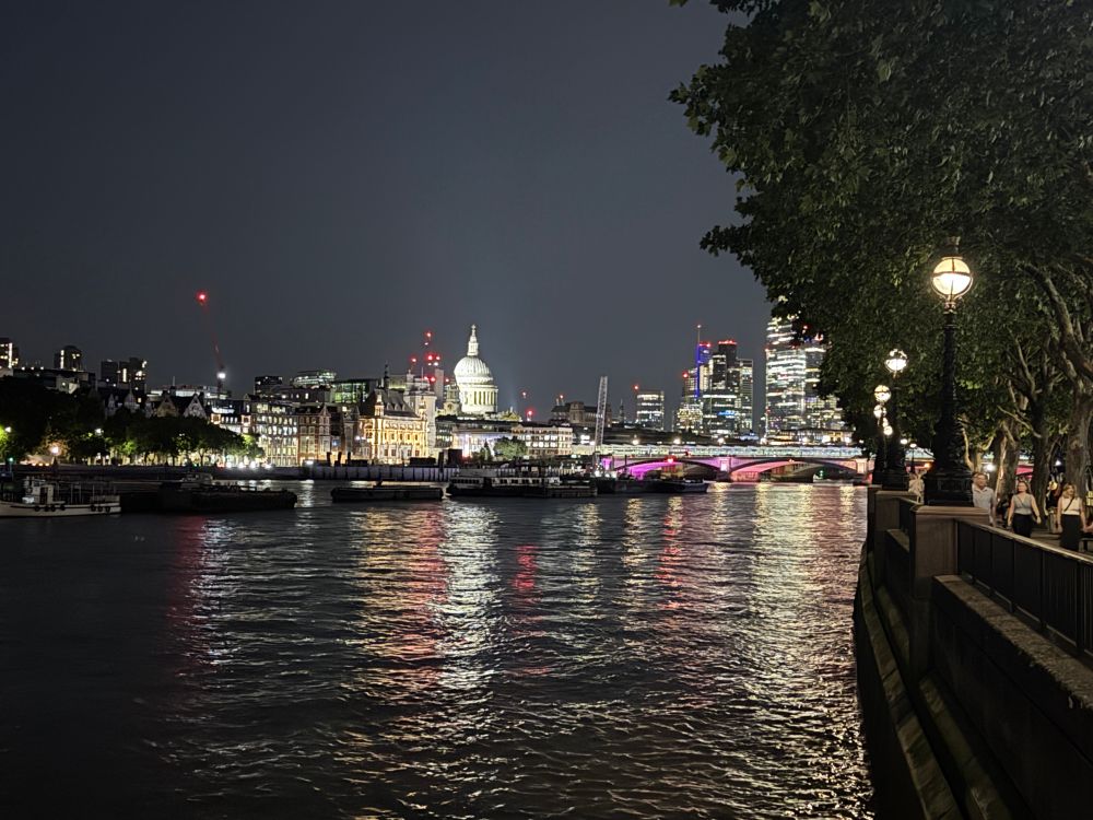 Photo taken at night time, looking out from the south bank of the Thames (near the National Theatre), along the river towards St Paul’s.