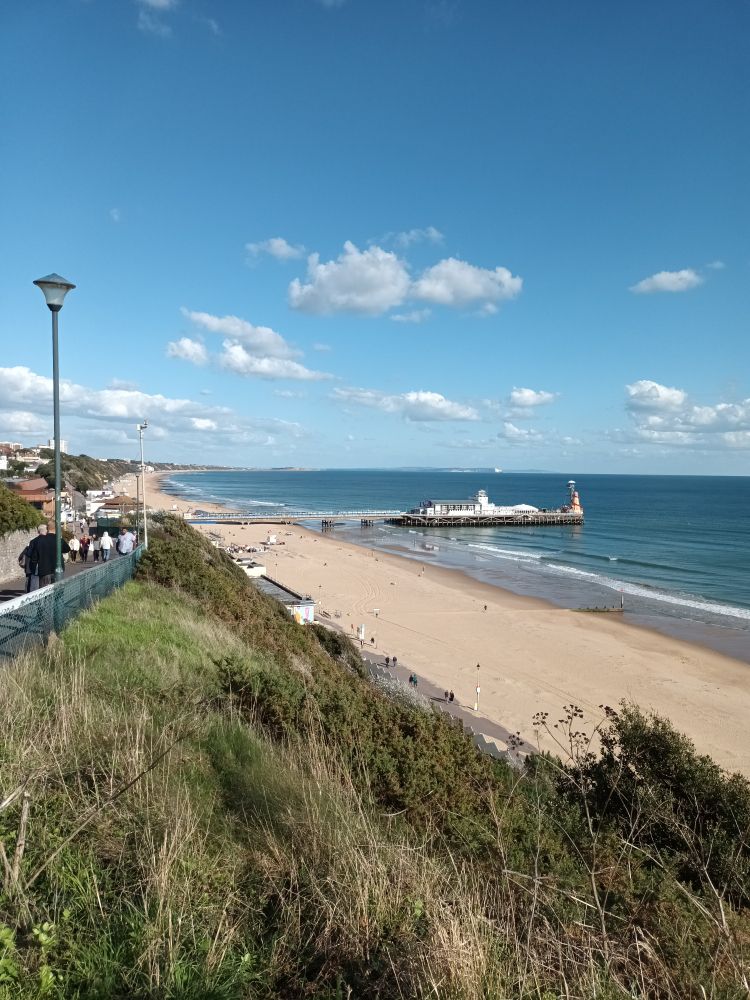 Bournemouth beach in sunshine, with blue sea and small clouds. 