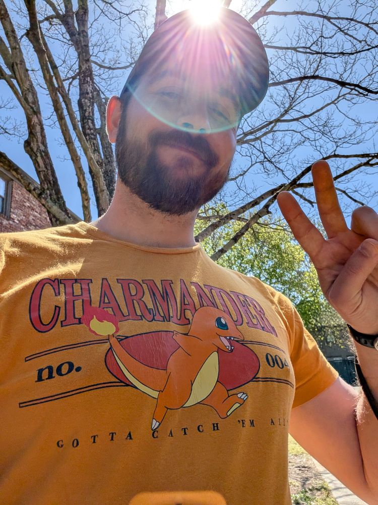 Rob, wearing an orange shirt with Charmander on it