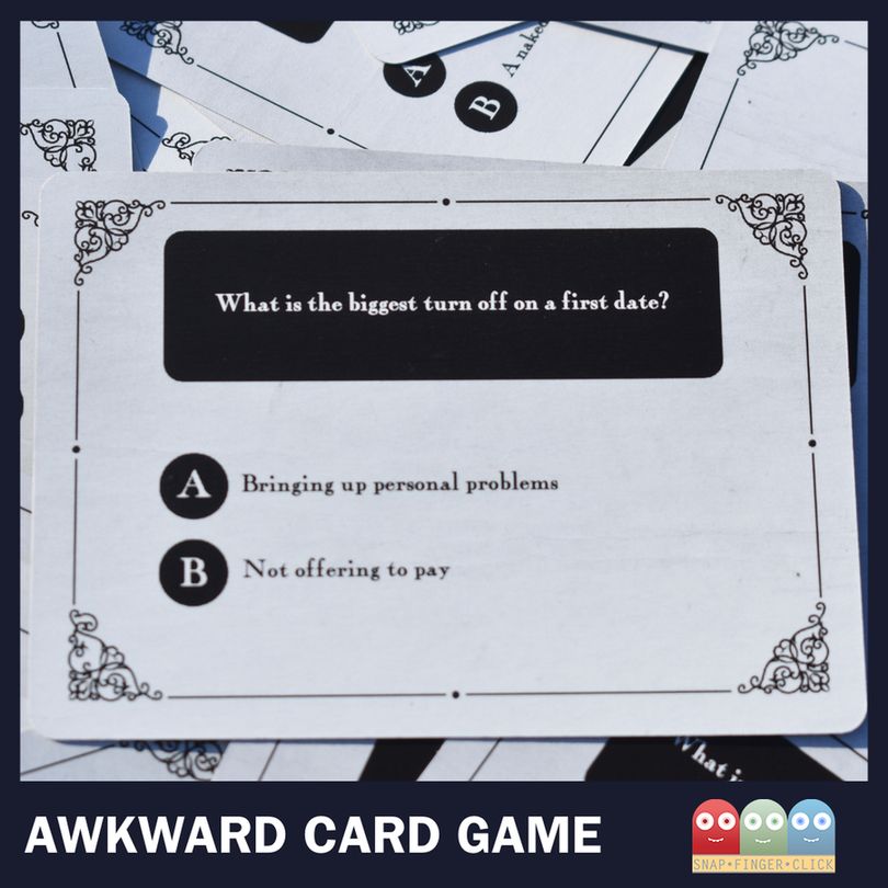 A close-up of a card from the Awkward Card Game asking: "What is the biggest turn off on a first date?" with options A) Bringing up personal problems and B) Not offering to pay. Other cards are visible in the background.