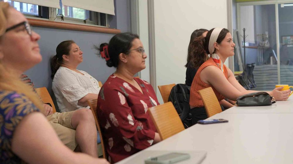 A group of people in the audience of a presentation.