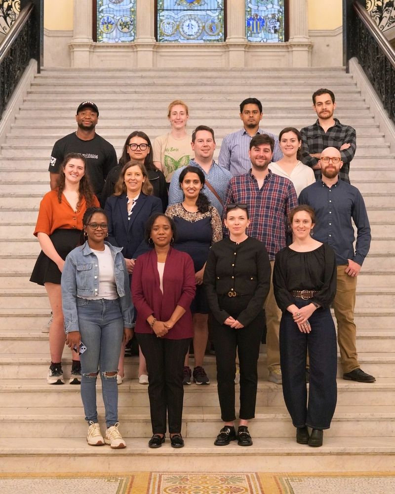 Group of students smiling on grand staircase.
