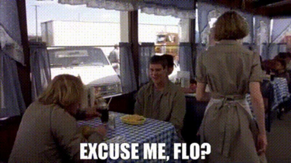 a group of people are sitting at a table in a restaurant with the words excuse me flo written on the bottom