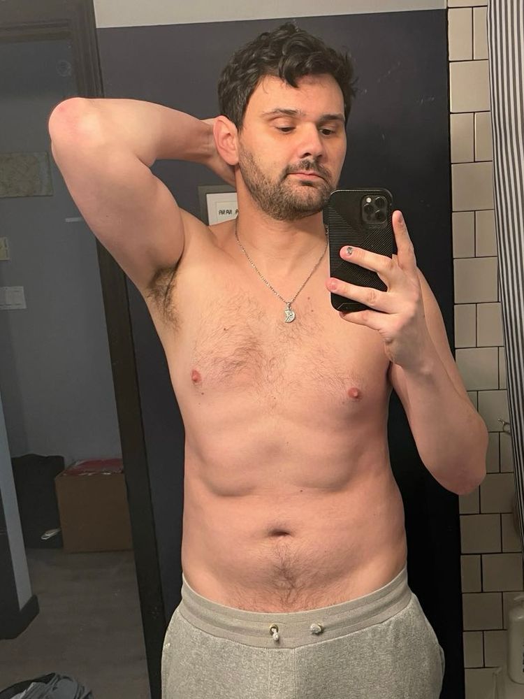 Mirror selfie of me shirtless. The band of grey sweatpants is visible