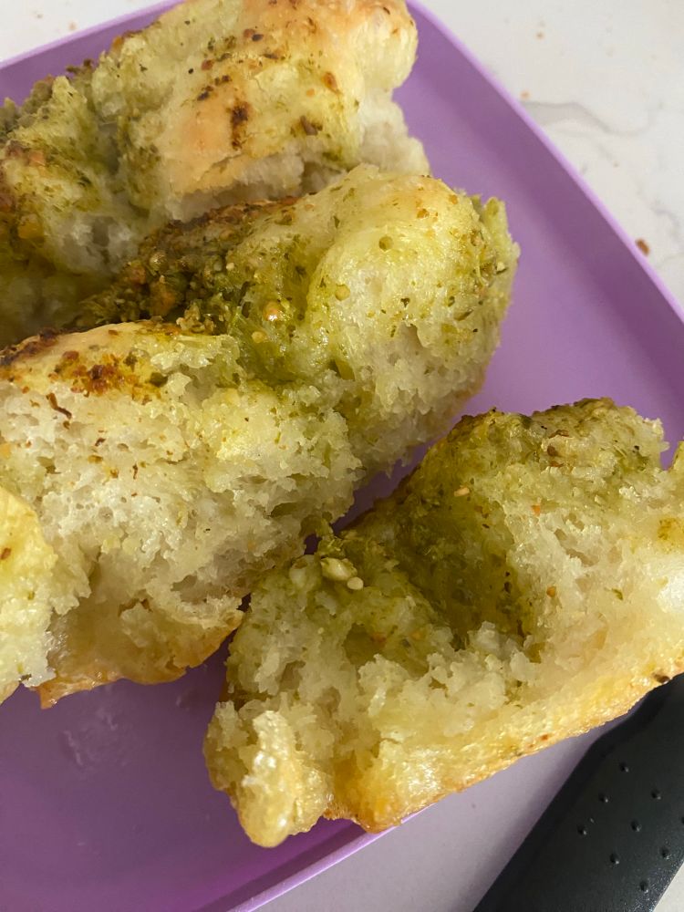 Focaccia bread with pesto baked in, cut on a plate 