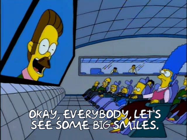 a cartoon says okay everybody let 's see some big smiles in front of a large screen