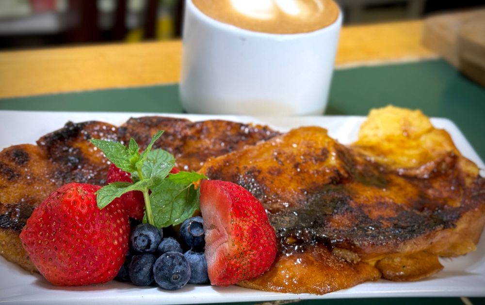 French toast, berries, cappuccino. 
