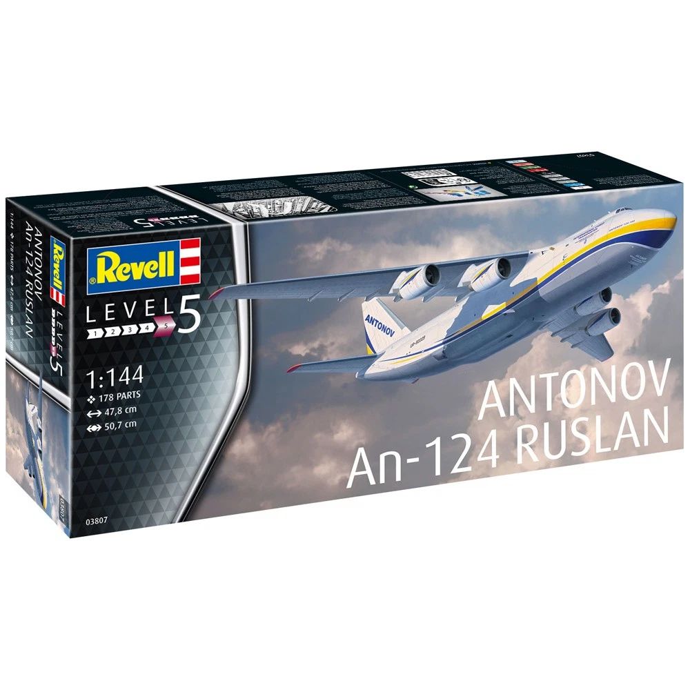 A box for a model of the Antonov An-124 Ruslan airplane is pictured, featuring detailed artwork of the aircraft.

The scene composition is a box showcasing a model kit. The box's front prominently features a detailed illustration of the Antonov An-124 Ruslan aircraft, which fills most of the visible space.  The image is clearly a depiction of a model aircraft, not a real-world scene.  The aircraft is depicted in a three-quarter view, with its wings and body clearly visible. The angle allows for the viewing of various details.  The image is well-centered within the box design.

The key subject is the Antonov An-124 Ruslan airplane.  The model is depicted with great detail, showing the plane's large size, distinctive shape, and various markings, such as the distinctive markings. The model appears to be a detailed representation of the real aircraft.  The image highlights the model's features and components.

The artistic medium is photographic, likely a scan or digital rendering of a model kit box art.  The illustration showcases high-quality graphics with crisp lines and realistic details for an airplane.  The style is illustrative, focused on visual representation of the aircraft.  The creative choice highlights the design and engineering of the aircraft.

The setting is the box itself. The box art's background is clean and plain, providing a stark contrast and clear focus on the aircraft. Lighting appears to be ambient studio lighting, resulting in consistent illumination across the plane's body. There are no elements besides the plane and the box to create any mood or atmosphere; the mood is practical.