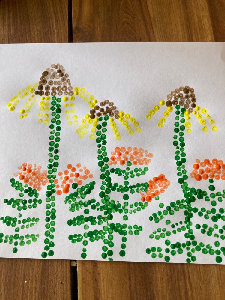 A homemade painting depicting yellow coneflowers and orange butterfly weed, rendered in dots of tempera paint on white paper in a style inspired by Japanese artist Yayoi Kusama.