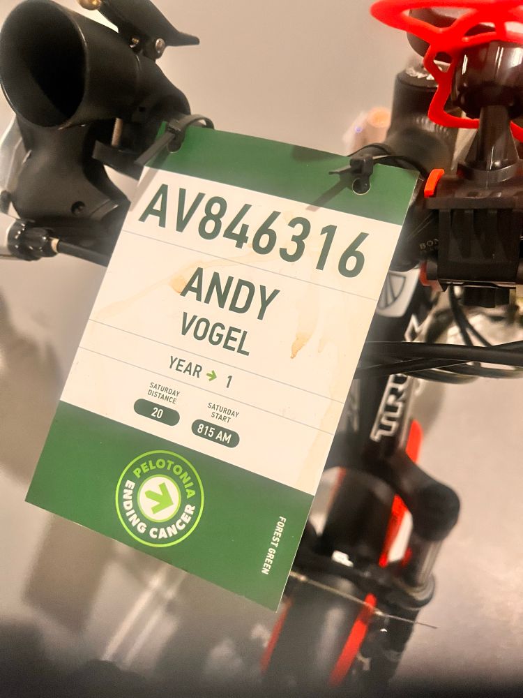 A bike tag with name and information on the handlebars of a bike 