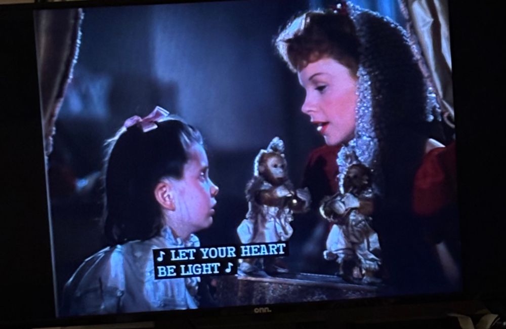 Ester and Tootie from Meet Me in St. Louis sitting in Tootie’s bedroom while Esther sings Have Yourself a Merry Little Christmas