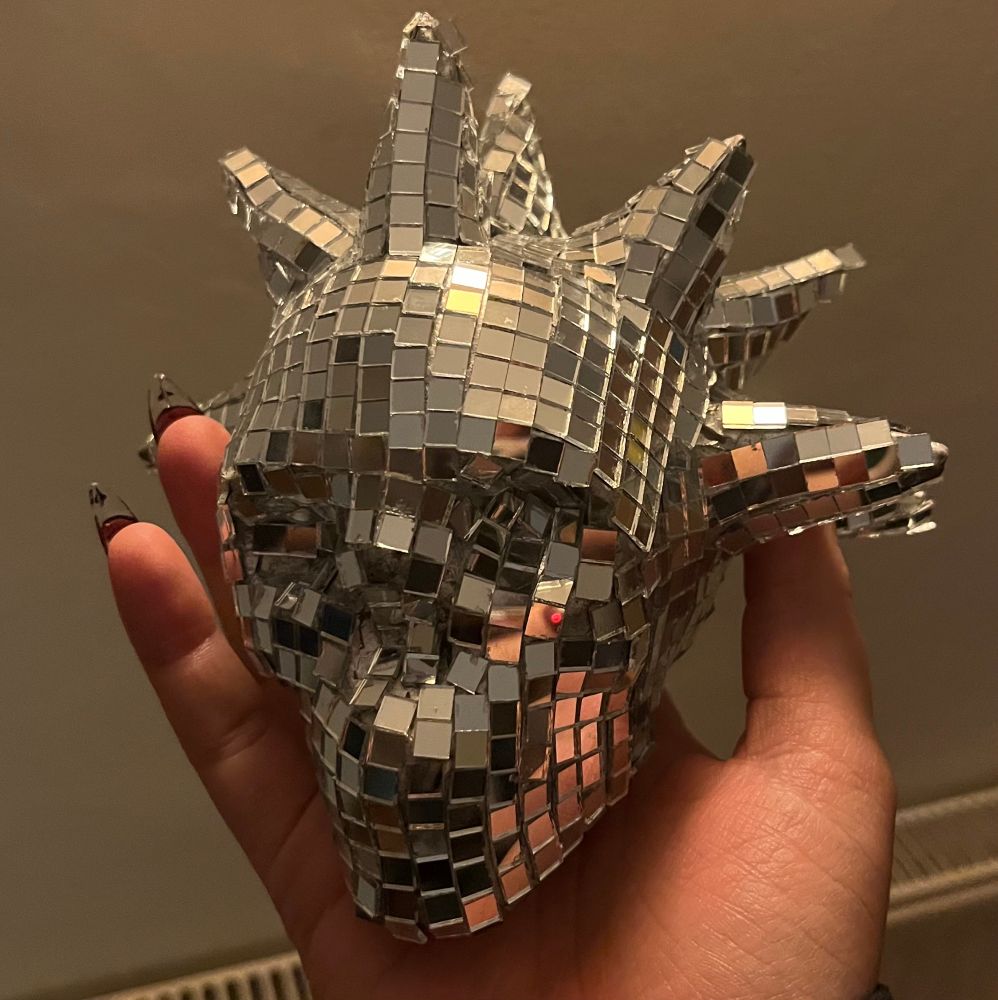 a disco ball skull with spikes coming out of its head 