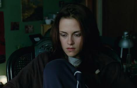 Kristen Stewart as Bella Swan in New Moon. she is sat in her bedroom facing the window, she is very depressed 