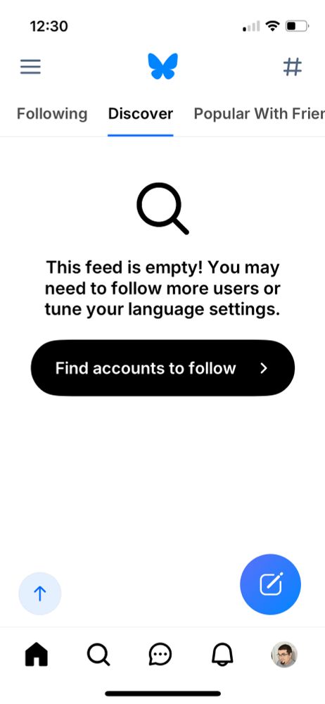 Screenshot of a mobile app Discover page, featuring a magnifying glass icon above the text: "This feed is empty! You may need to follow more users or tune your language settings." Below that, a button displays "Find accounts to follow" and an arrow. The app's bottom menu bar displays icons for Home, Search, Messages, Notifications, and Profile.  The top navigation includes a menu icon, a butterfly, and a hashtag icon, with "Discover" highlighted in the navigation bar.