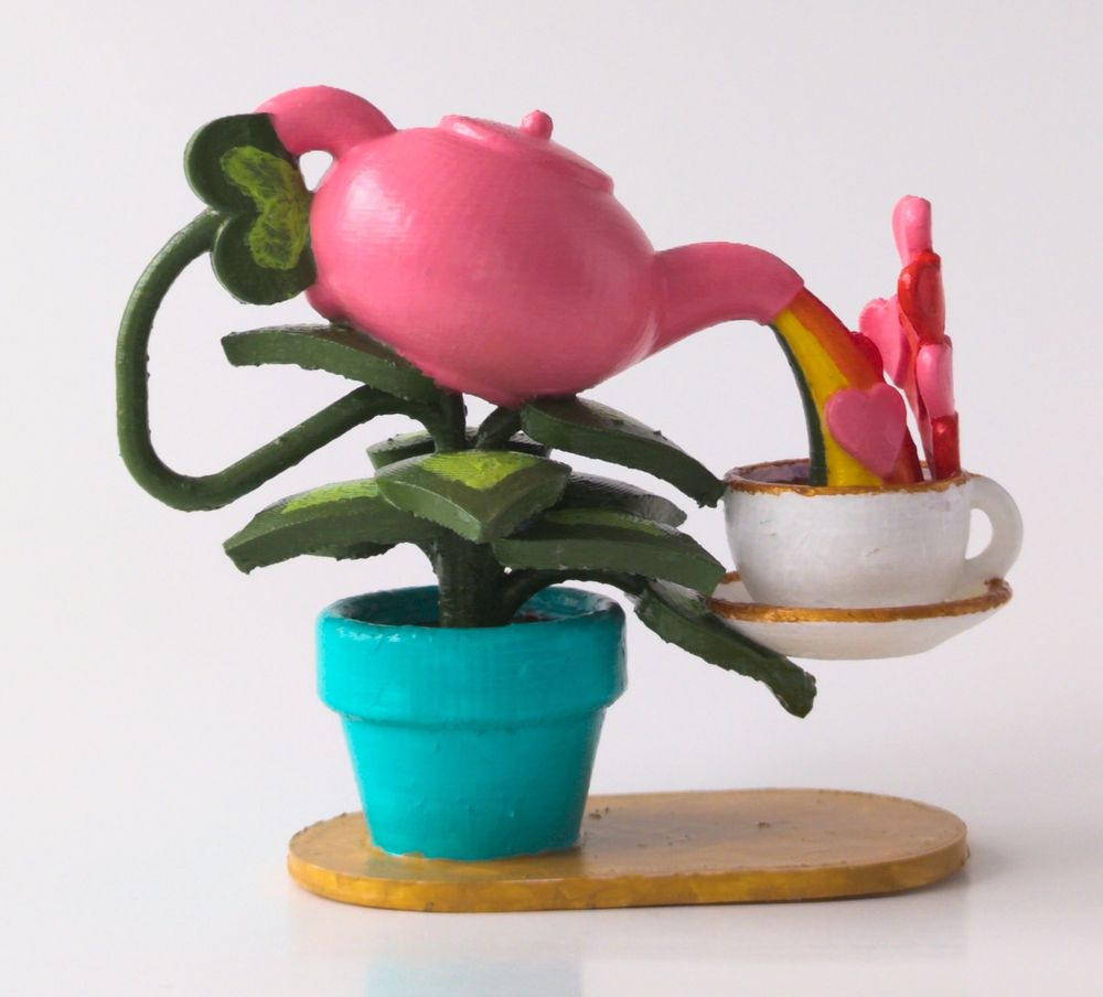 A small sculpture of a potted plant pouring tea full of love into a cup and saucer from a teapot.