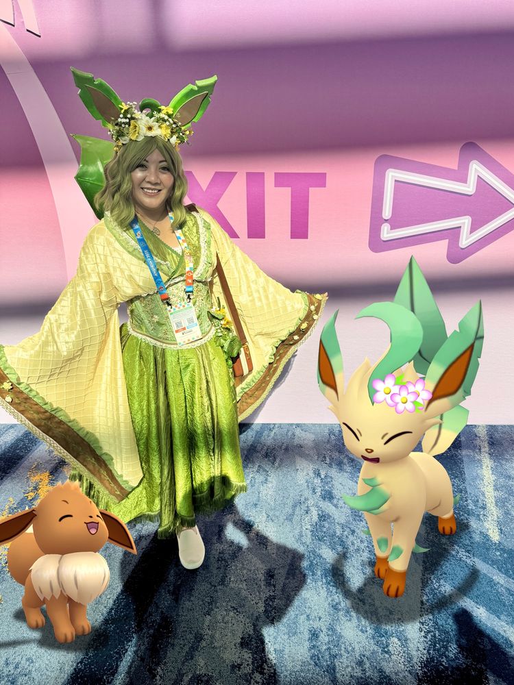 Eeveelution Cosplay dresses in all green to pair with her Leafeon partner. Eevee also joins the two in the convention hall.