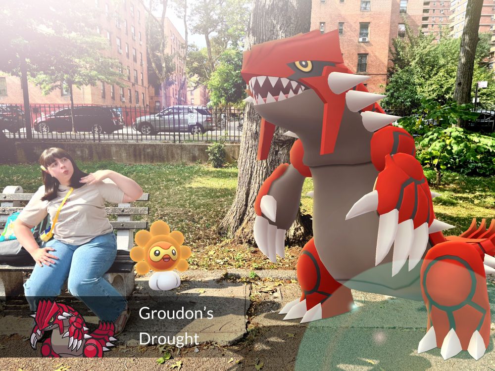 Julie sits on a park bench in the New York City summer heat. She is with her Castform, which has transformed into its Sunny Form due to being in the heat. The culprit? Groudon, whose ability Drought increases solar rays. (Pokémon GO #GOSnapshot)