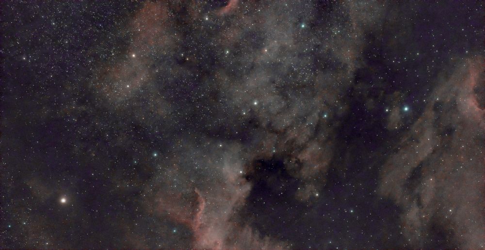 The North American Nebula, showing stars and colourful interstellar dust-particles and ionised-hydrogen gas.