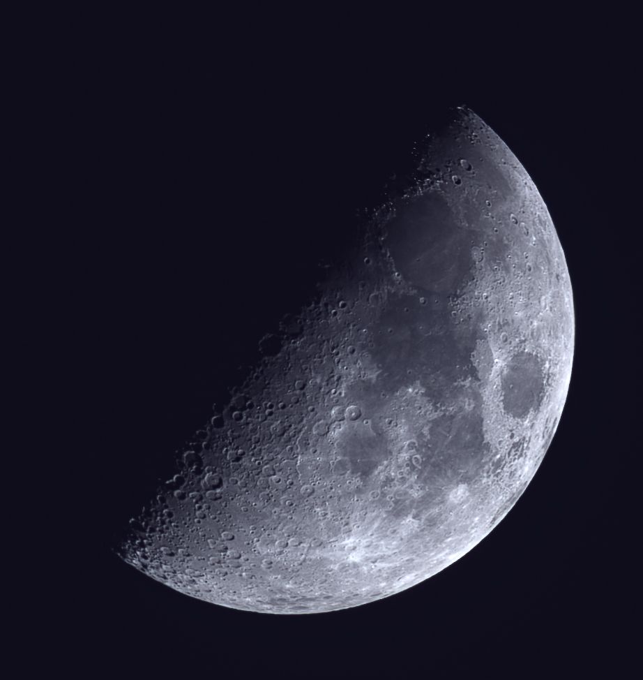 The Moon, about 50% waxing gibbous.