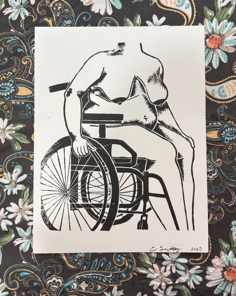 linocut print of a nude fat female body sitting in a manual wheelchair, black ink on white paper, dark floral/paisley fabric background 