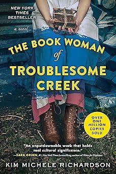 Book cover for The Book Woman of Troublesome Creek by Kim Michele Richardson. The cover shows a woman sitting on a bench, holding a book in her hands.