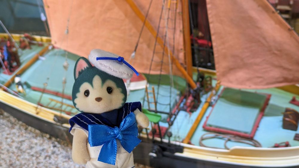 Bruce in front of a miniature sailboat 