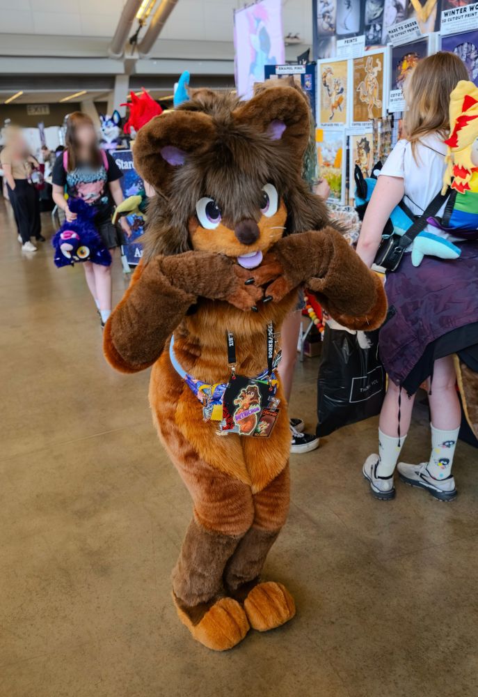 squirrel fursuiter (me) posing in the Anthrocon dealers den