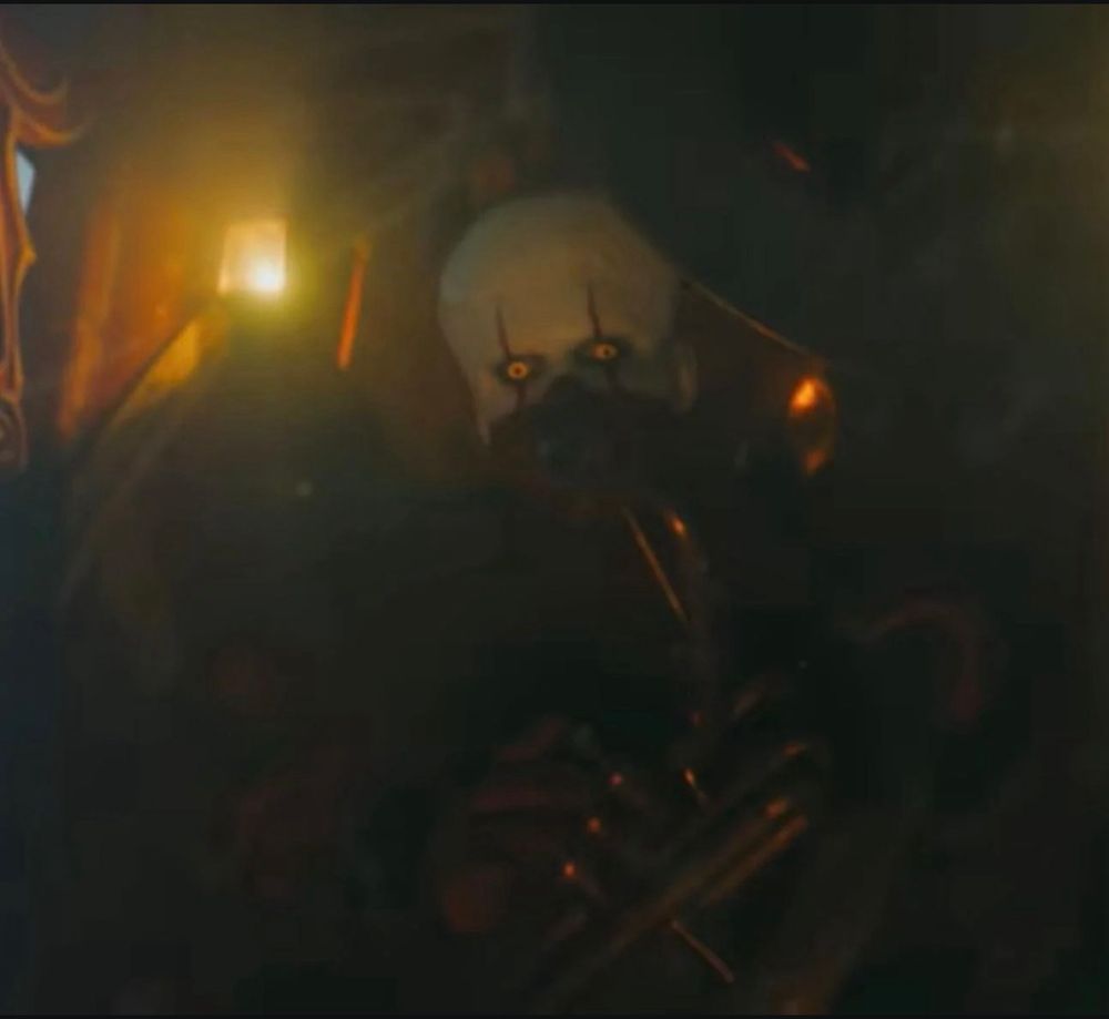 Pennywise from IT Welcome to Derry driving a circus wagon and playing a trombones from episode 8. 