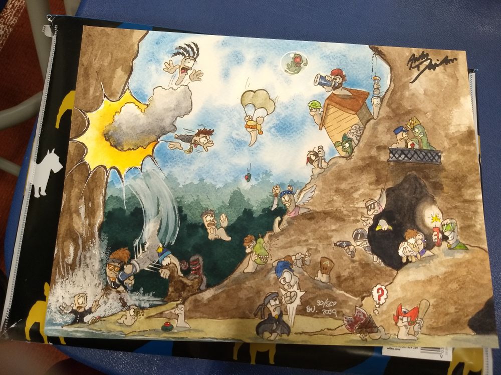 A photo of a watercolour artwork based on members of the Worms community, dated 2009, and it has just been signed at the top right corner by the Worms creator, Andy Davidson 