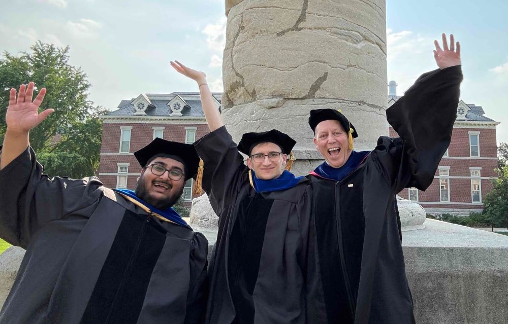 Shawn Thomas, Michael Pisias, and Chris Pires, having a fun photo in regalia at columns at the University of Missouri-Columbia