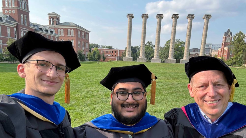 Michael Pisias, Shawn Thomas, Chris Pires, standing in regalia at columns at University of Missouri-Columbia