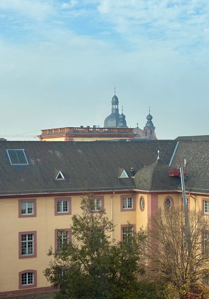 View of the part of the “schloss” (castle), grounds for Mannheim University with the Jesuit church steeple in the background. 