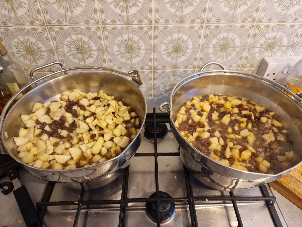 Two big jam pans filled with pears, sultanas, vinegar, sugar and spices, yum yum!