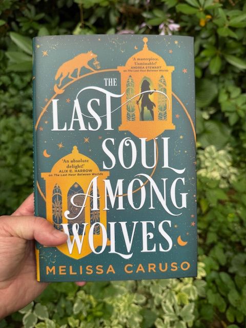 My hand holding a copy of the UK hardback of THE LAST SOUL AMONG WOLVES