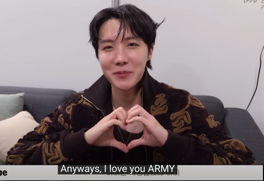 Screenshot of j-hope making a hand heart and saying "Anyways, I love you ARMY"