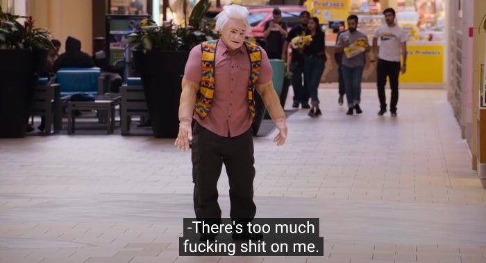 A fucked up old man made of badly applied prosthetics that makes him look rubbery and weird says "there's too much fucking shit on me"