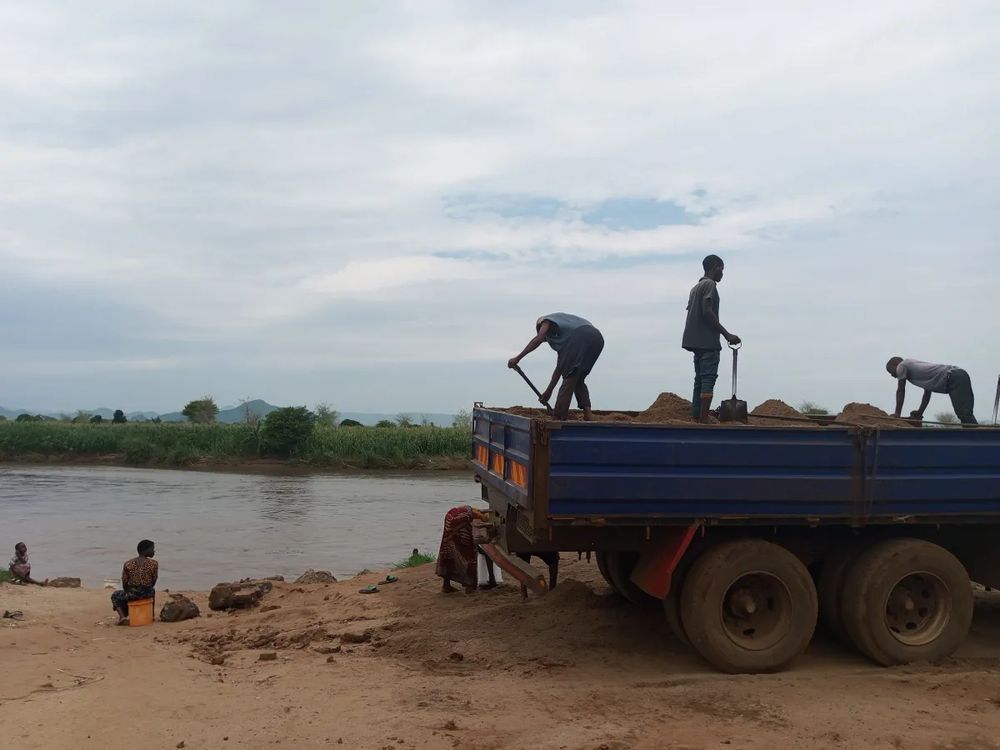 Men mining sand by hand. This back breaking work, often undertaken by the world's poorest people, supplies the right consistency of sand needed to make concrete. Desert sand, for instance, is too smooth to be useful for building. Sand can be pounded into the right shape but that's an expensive process. So, instead, river beds, sea beds, estuaries, lake beds, are being dug for sand - harming wildlife, creating deeper water bodies more susceptible to algal blooms, & causing the erosion of banks, with the loss of people's homes & some of the world's finest farmland. This erosion encourages salt water ingress - making well water undrinkable. 