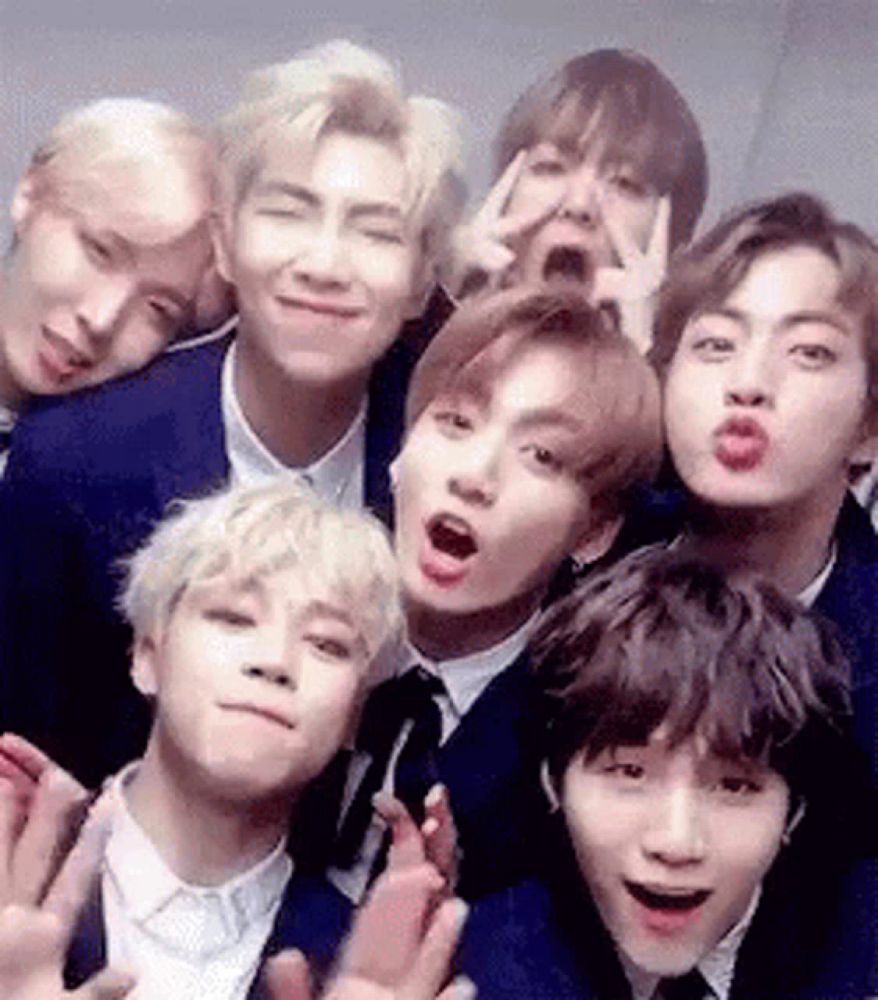 a group of young men are posing for a picture in a photo booth .